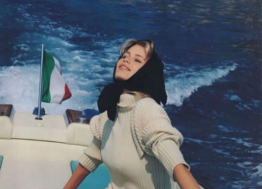 Woman sitting at the back of luxury boat